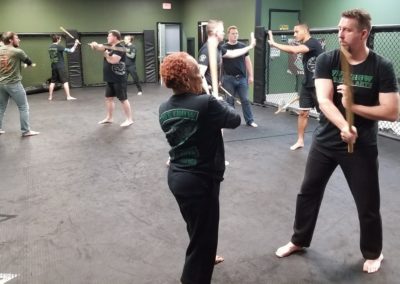 Picture of people of all ages doing weapons training at Five Crow Martial Arts in Hampton, VA